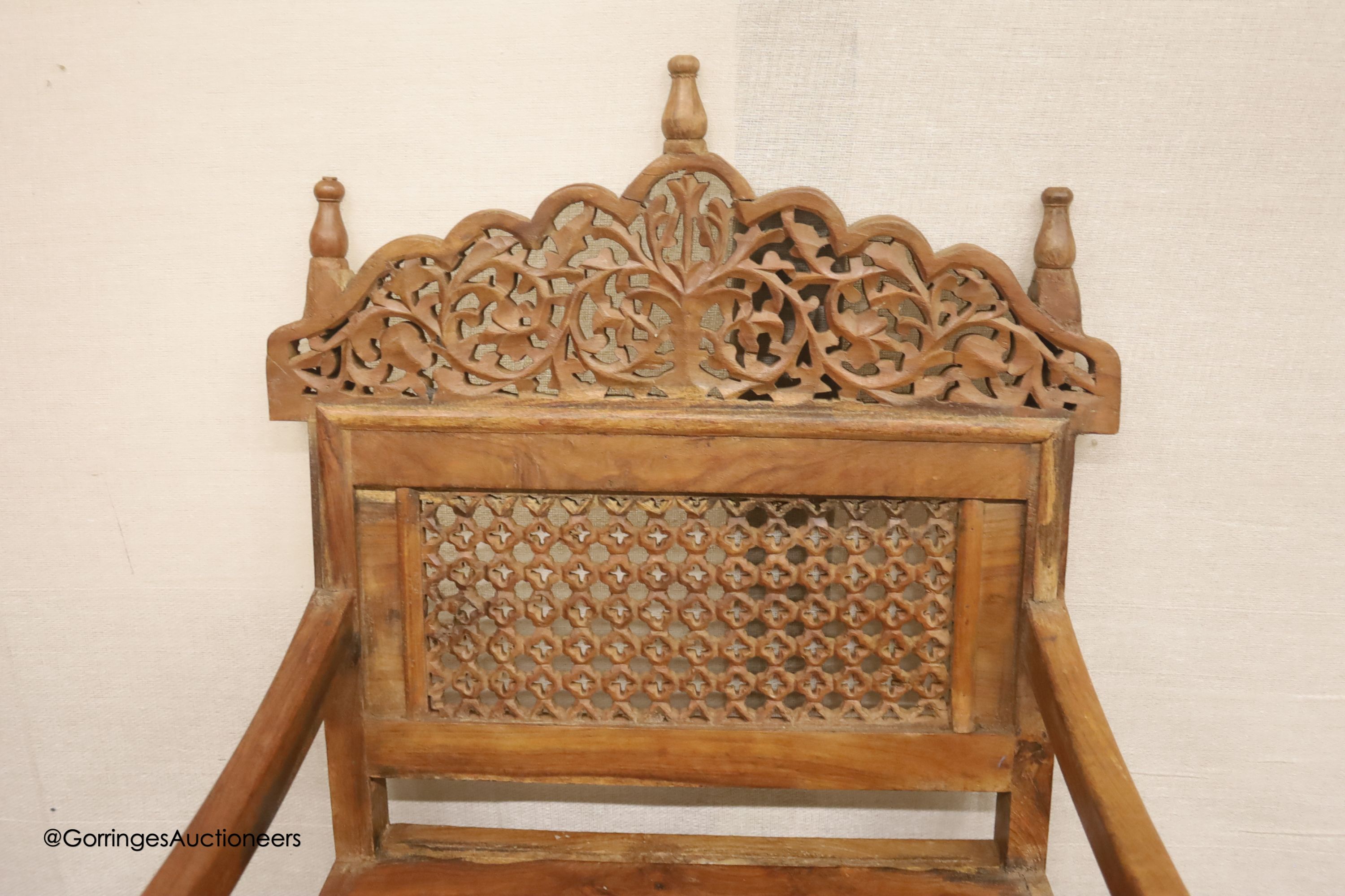 An Anglo-Indian carved hardwood elbow chair, width 55cm, depth 48cm, height 98cm